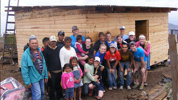 Groups in front of a building they are constructing