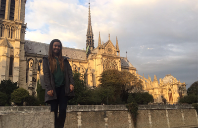 Audrey Bradley standing in front of the Notre Dame Cathedral, Paris, France