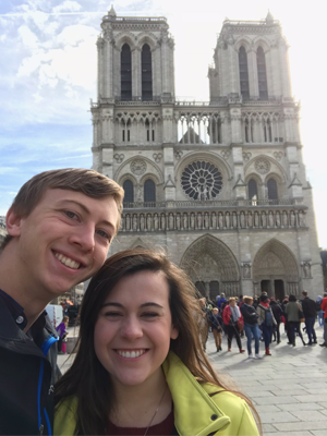 Couple standing in front of the Notre Dame Cathedral, Paris, France