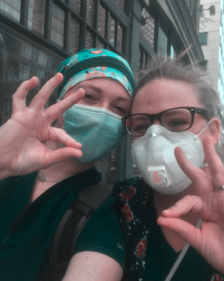 Nici and other nurse wearing masks, doing chap hand sign