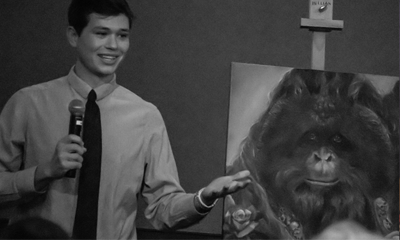 Student in front of orangutan painting